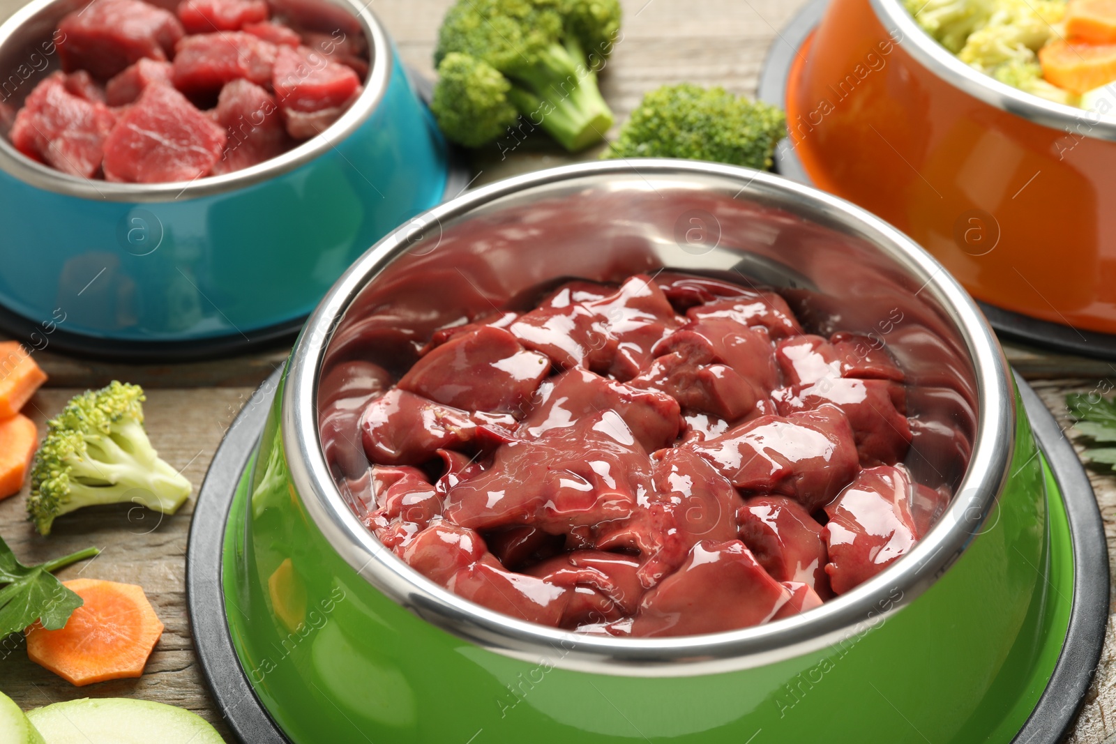 Photo of Pet food. Natural products on wooden table, closeup