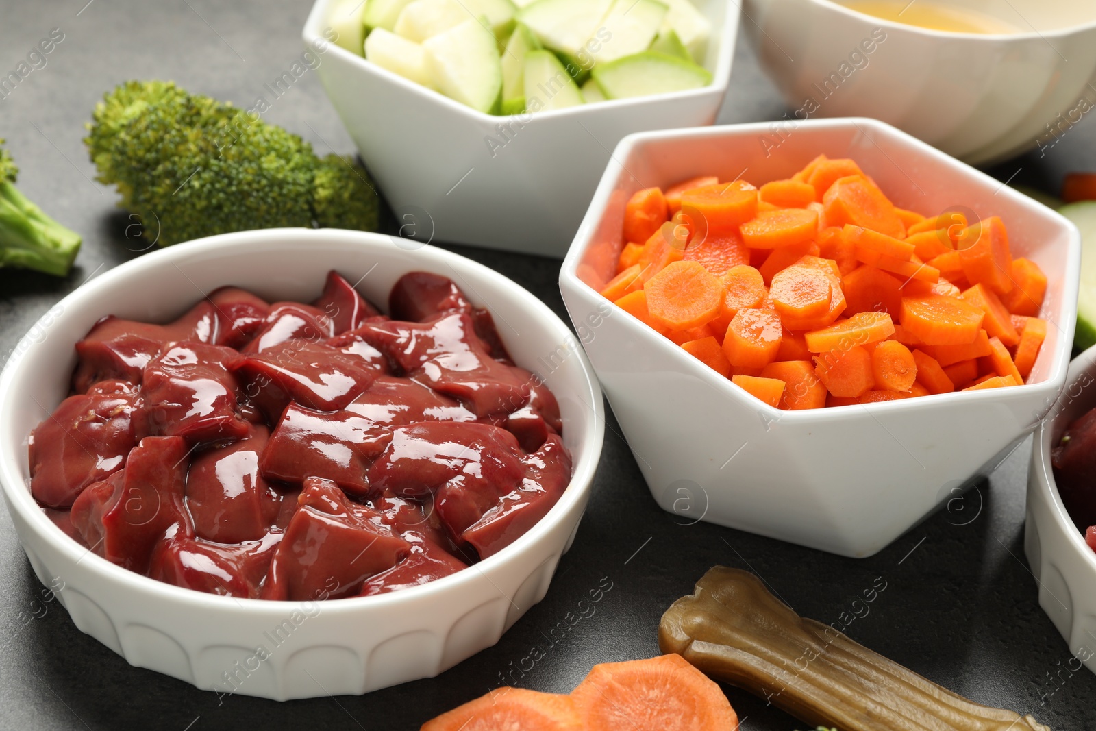 Photo of Pet food. Natural products on grey table, closeup