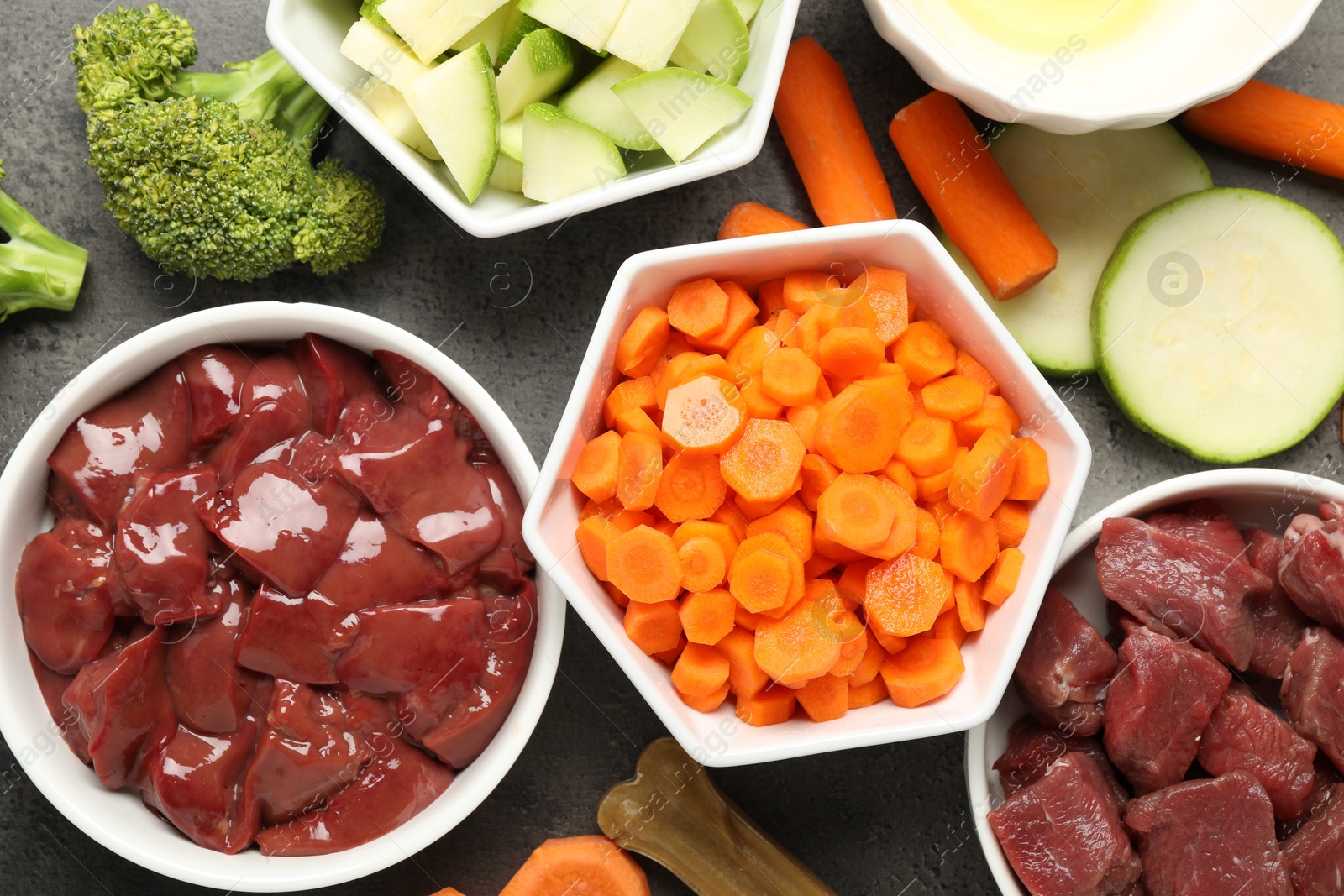 Photo of Pet food. Natural products on grey table, top view