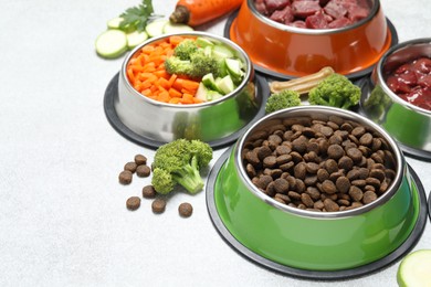 Photo of Dry pet food and natural products on light table, closeup