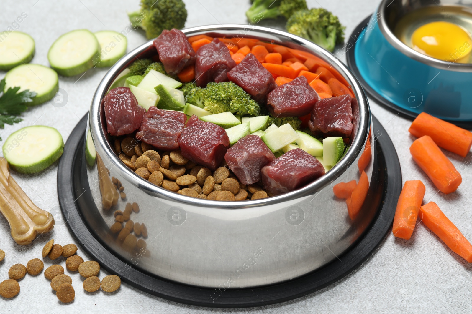 Photo of Dry pet food and natural products on light table, closeup