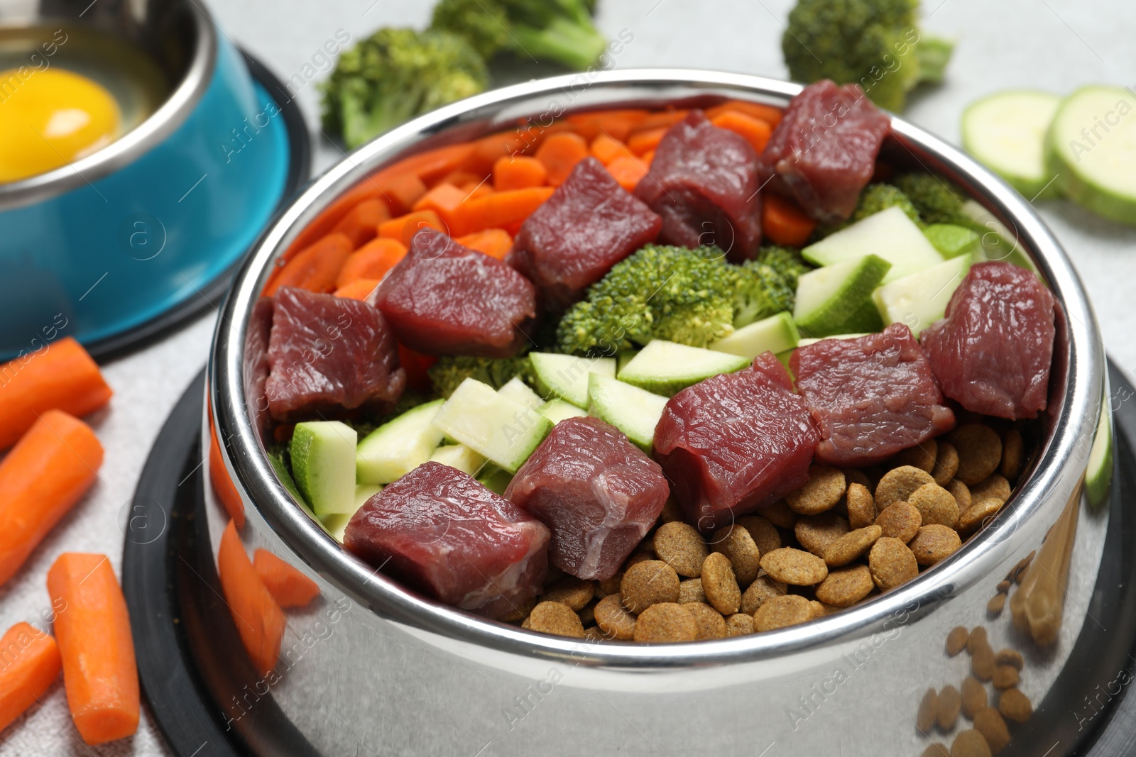 Photo of Dry pet food and natural products on light table, closeup