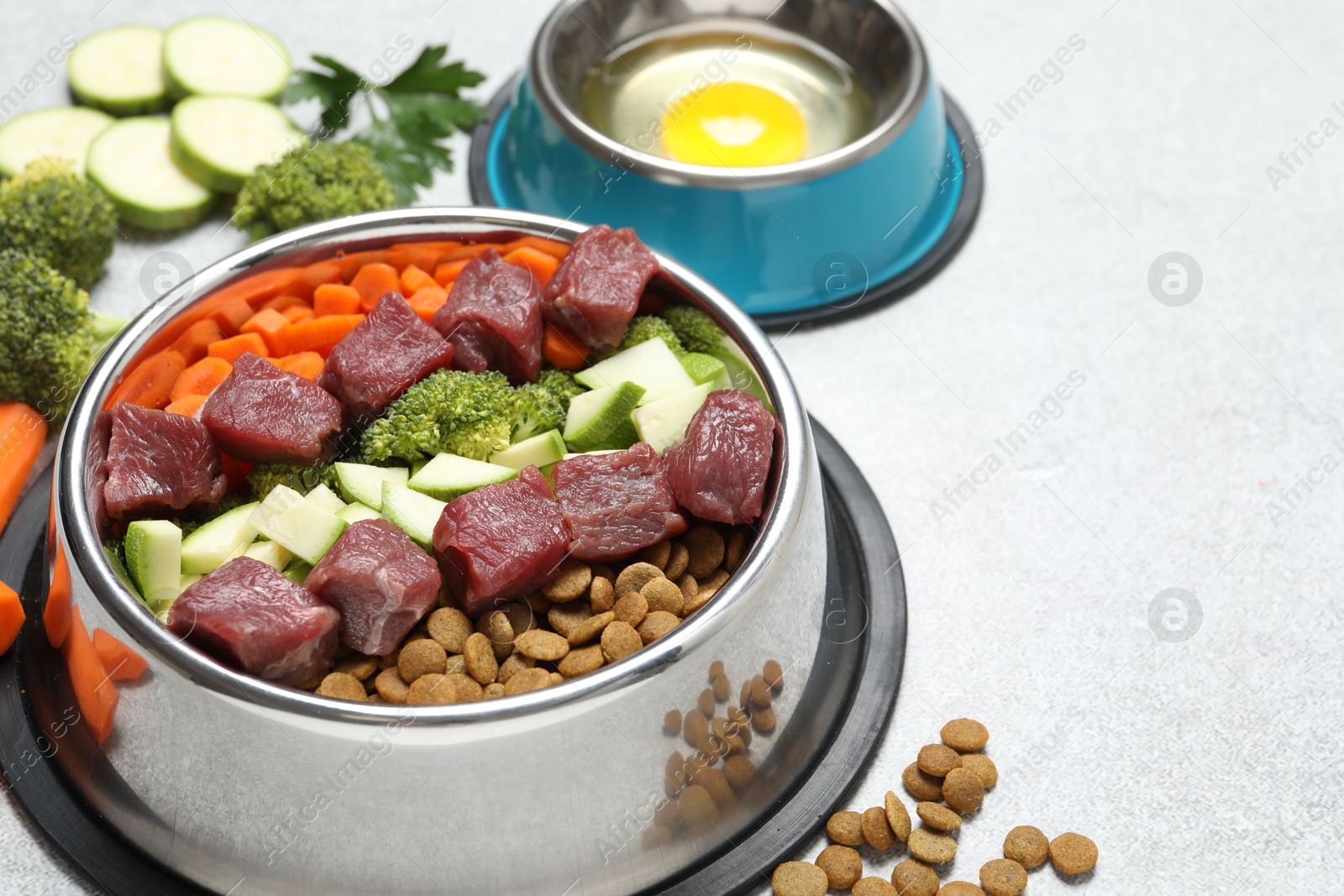 Photo of Dry pet food and natural products on light table, closeup