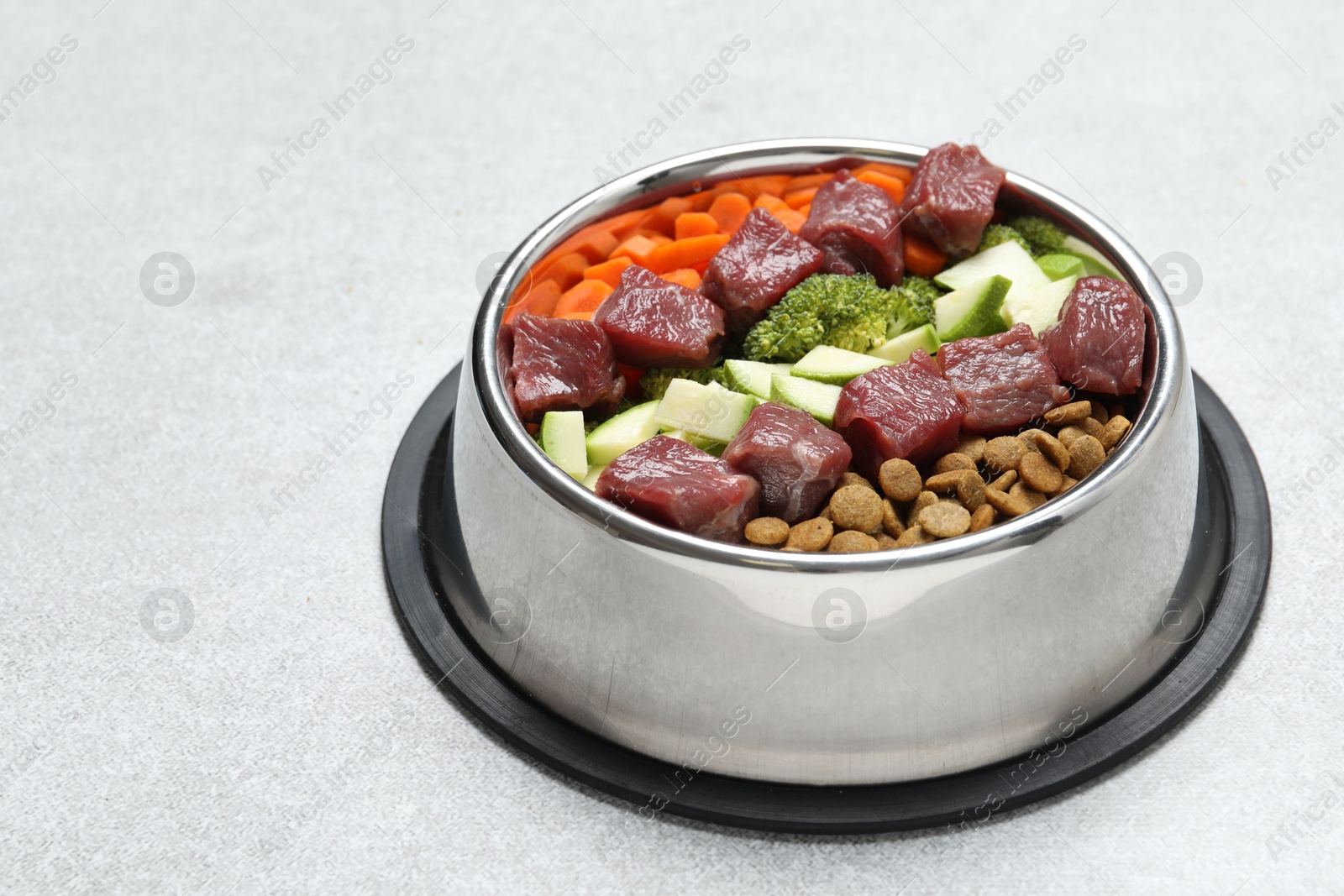 Photo of Dry pet food and natural products on light table, closeup