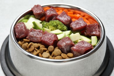 Photo of Dry pet food and natural products on light table, closeup