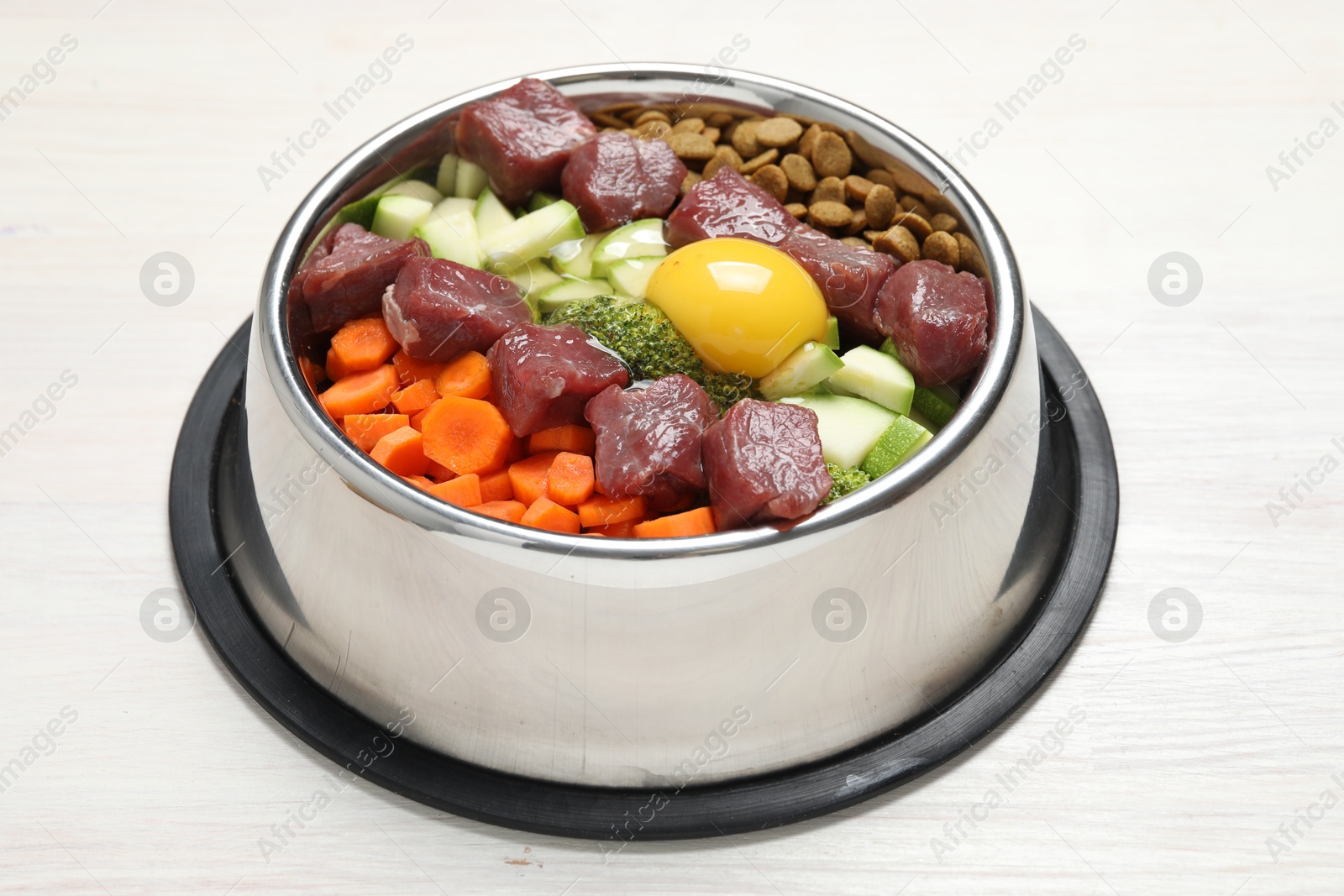 Photo of Dry pet food and natural products on white wooden table, closeup