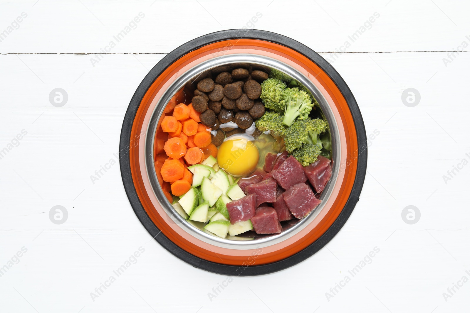 Photo of Dry pet food and natural products on white table, top view