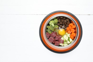 Photo of Dry pet food and natural products on white table, top view