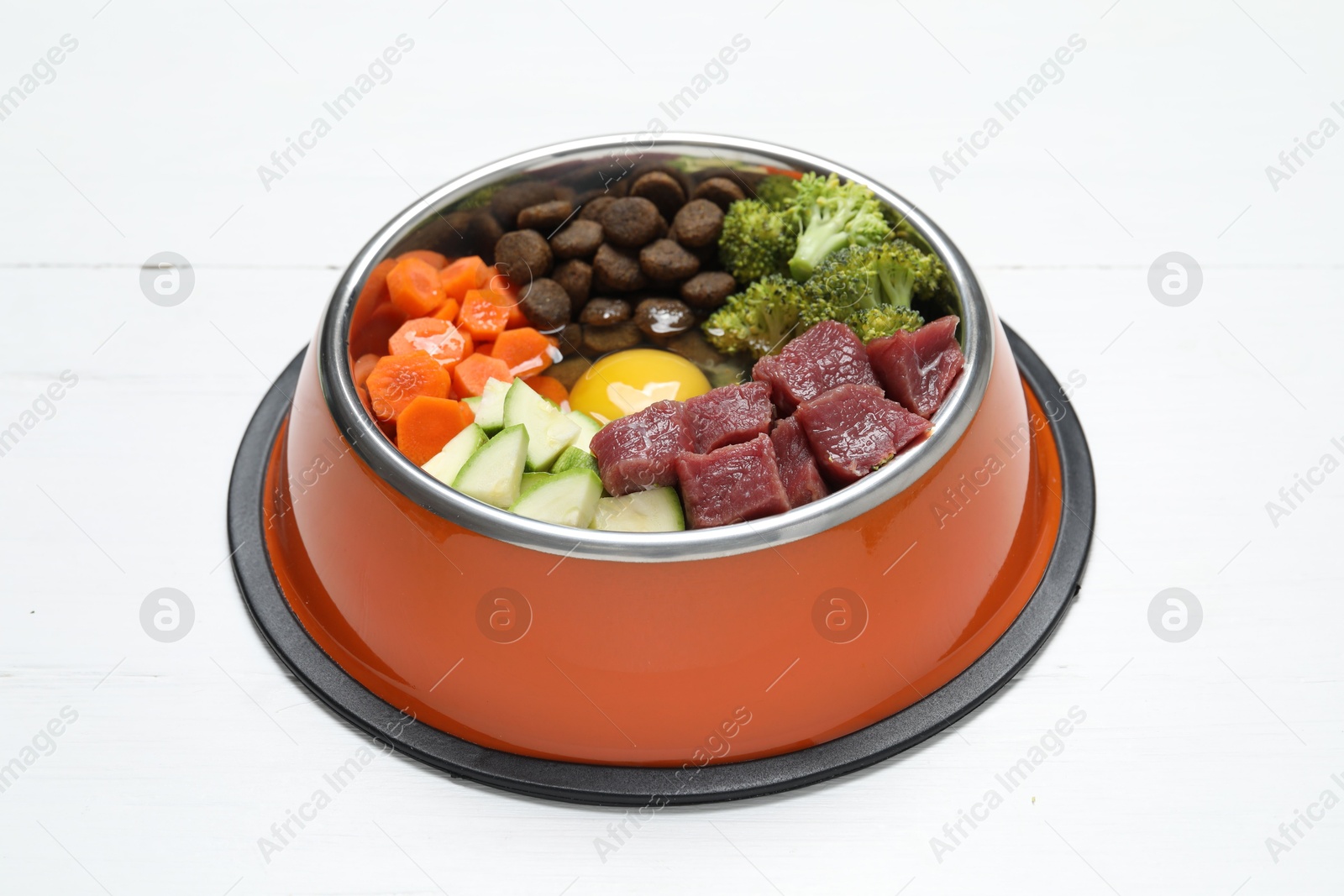 Photo of Dry pet food and natural products on white wooden table, closeup