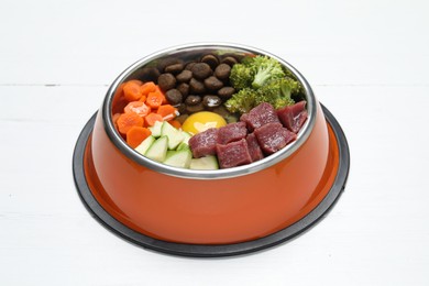 Photo of Dry pet food and natural products on white wooden table, closeup