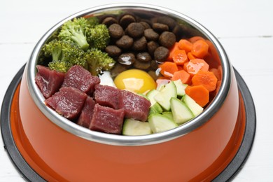 Photo of Dry pet food and natural products on white wooden table, closeup