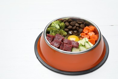 Photo of Dry pet food and natural products on white wooden table, closeup