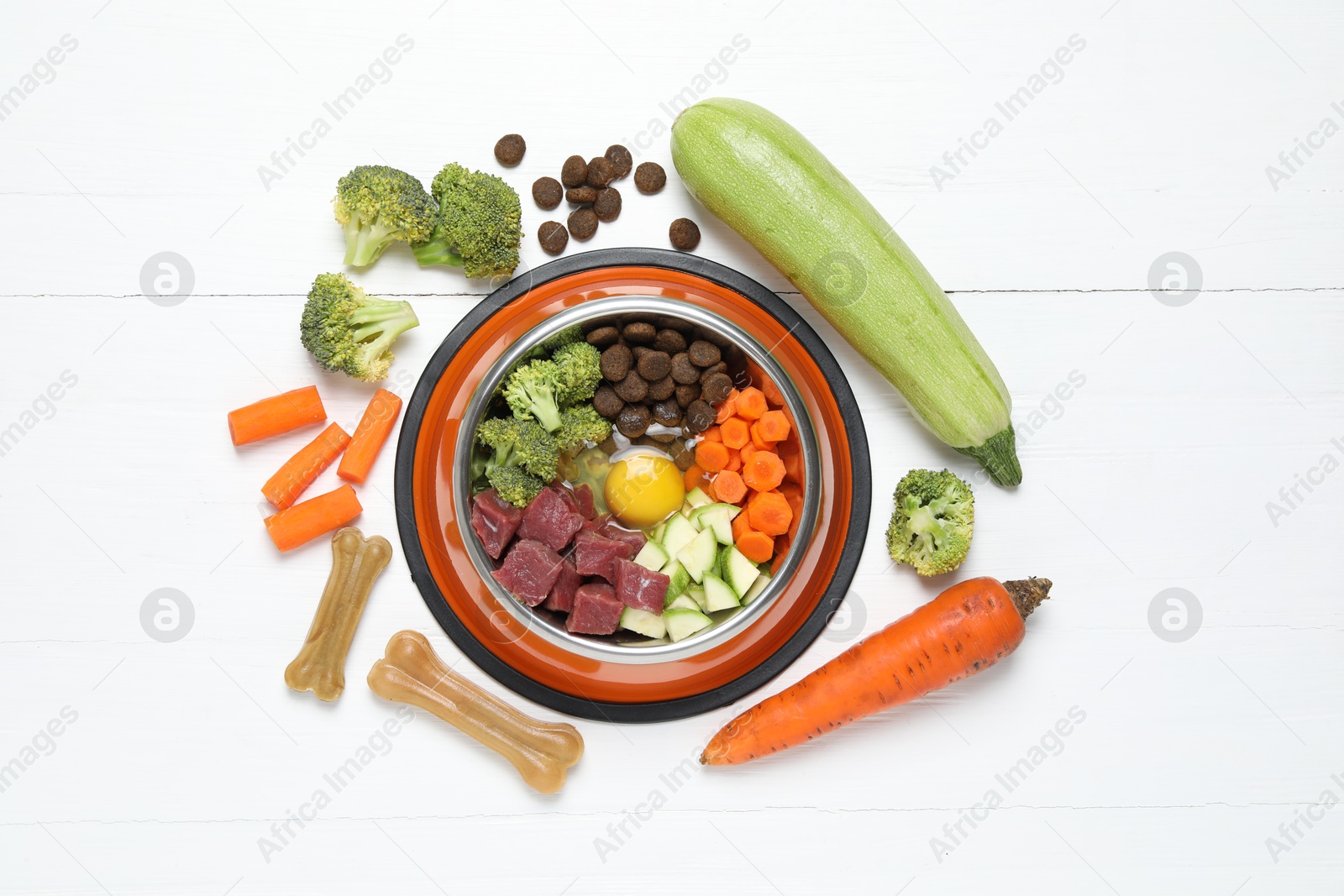 Photo of Dry pet food and natural products on white table, top view