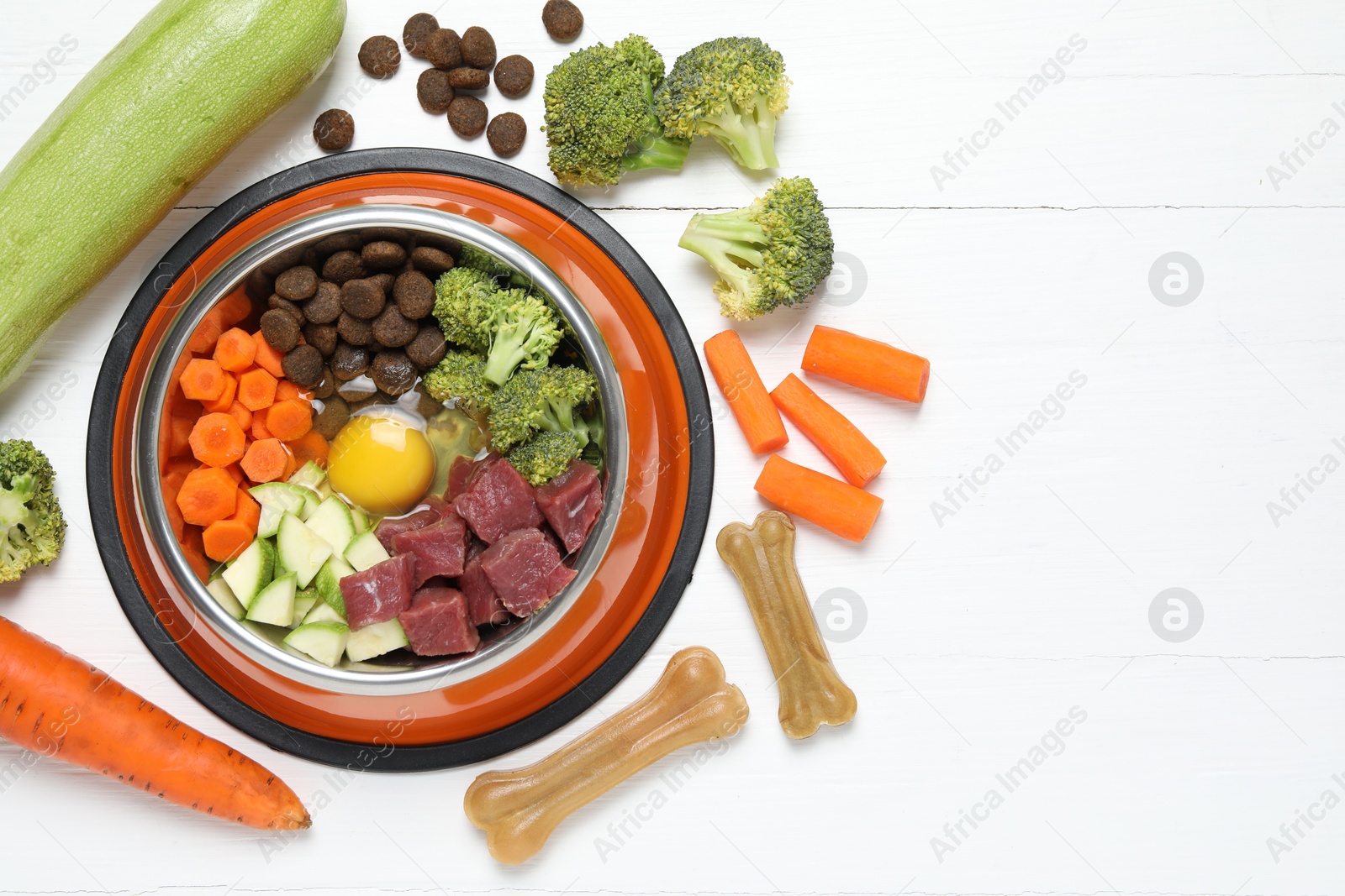 Photo of Dry pet food and natural products on white table, top view