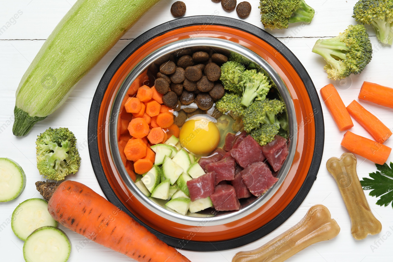 Photo of Dry pet food and natural products on white table, top view