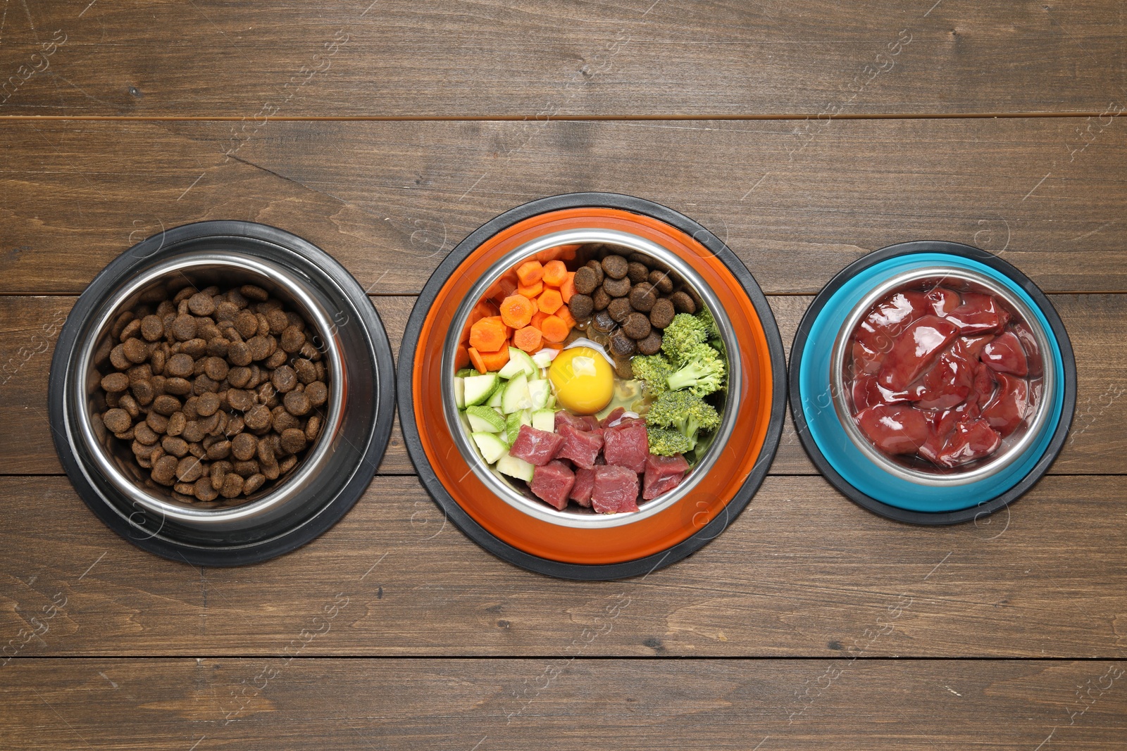 Photo of Dry pet food and natural products on wooden table, top view