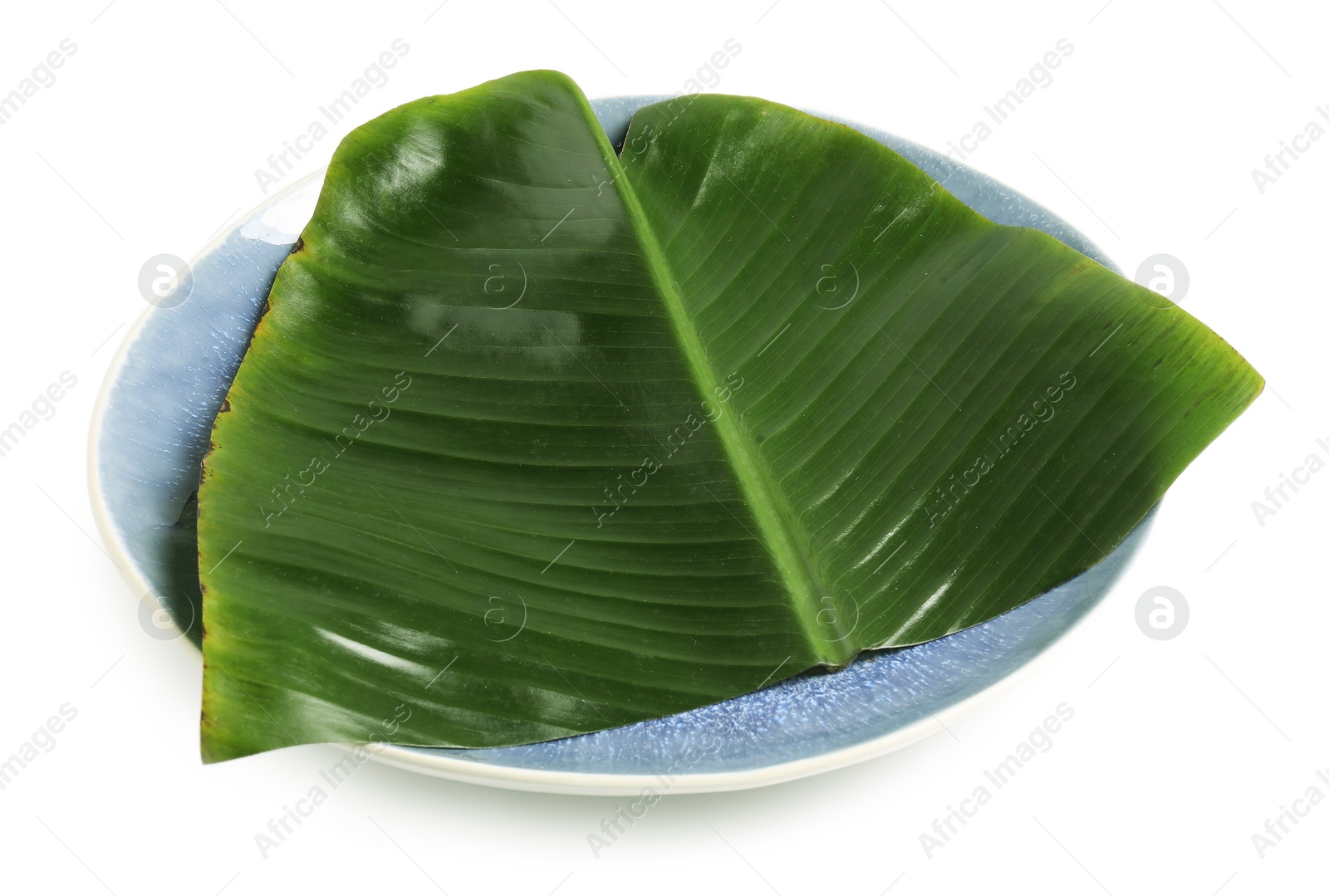 Photo of Plate with cut banana leaf isolated on white. Healthy eco serving