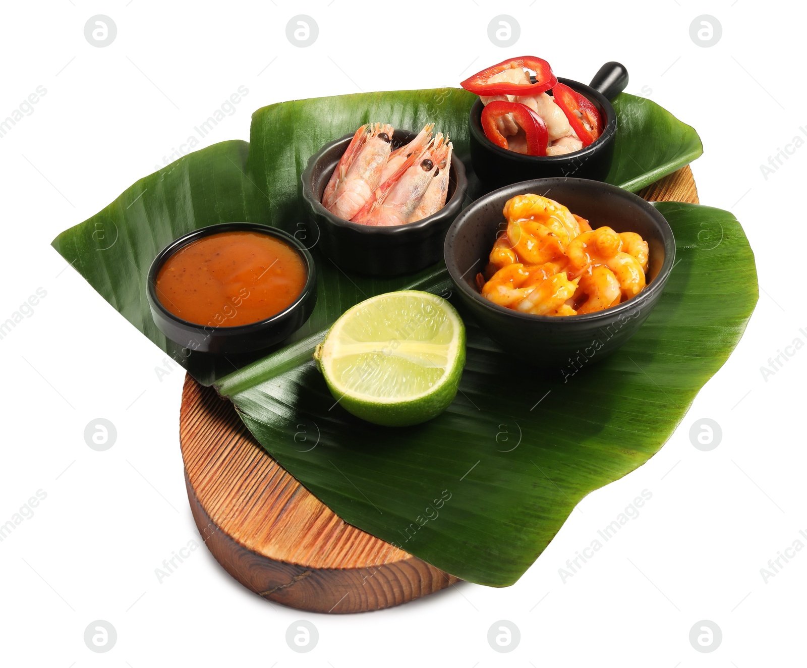 Photo of Cut banana leaf with different food and sauce isolated on white. Healthy eco serving