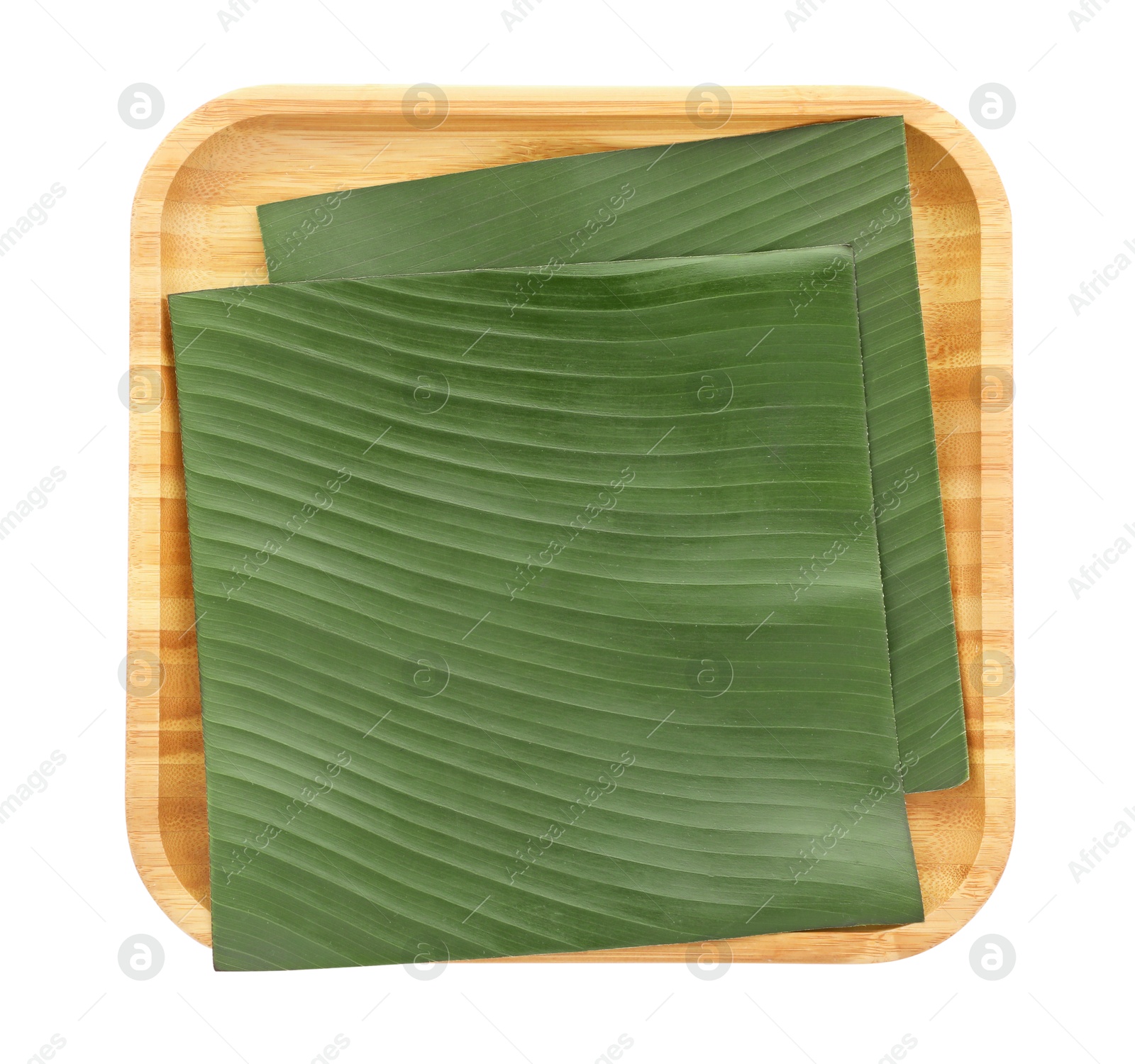 Photo of Pieces of banana leaves isolated on white, top view. Traditional meal serving