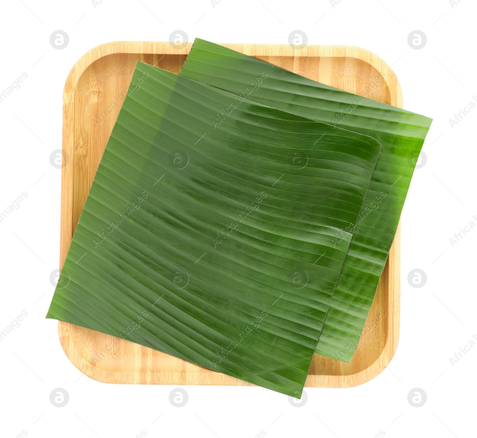 Photo of Pieces of banana leaves isolated on white, top view. Traditional meal serving