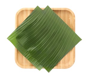 Photo of Pieces of banana leaves isolated on white, top view. Traditional meal serving