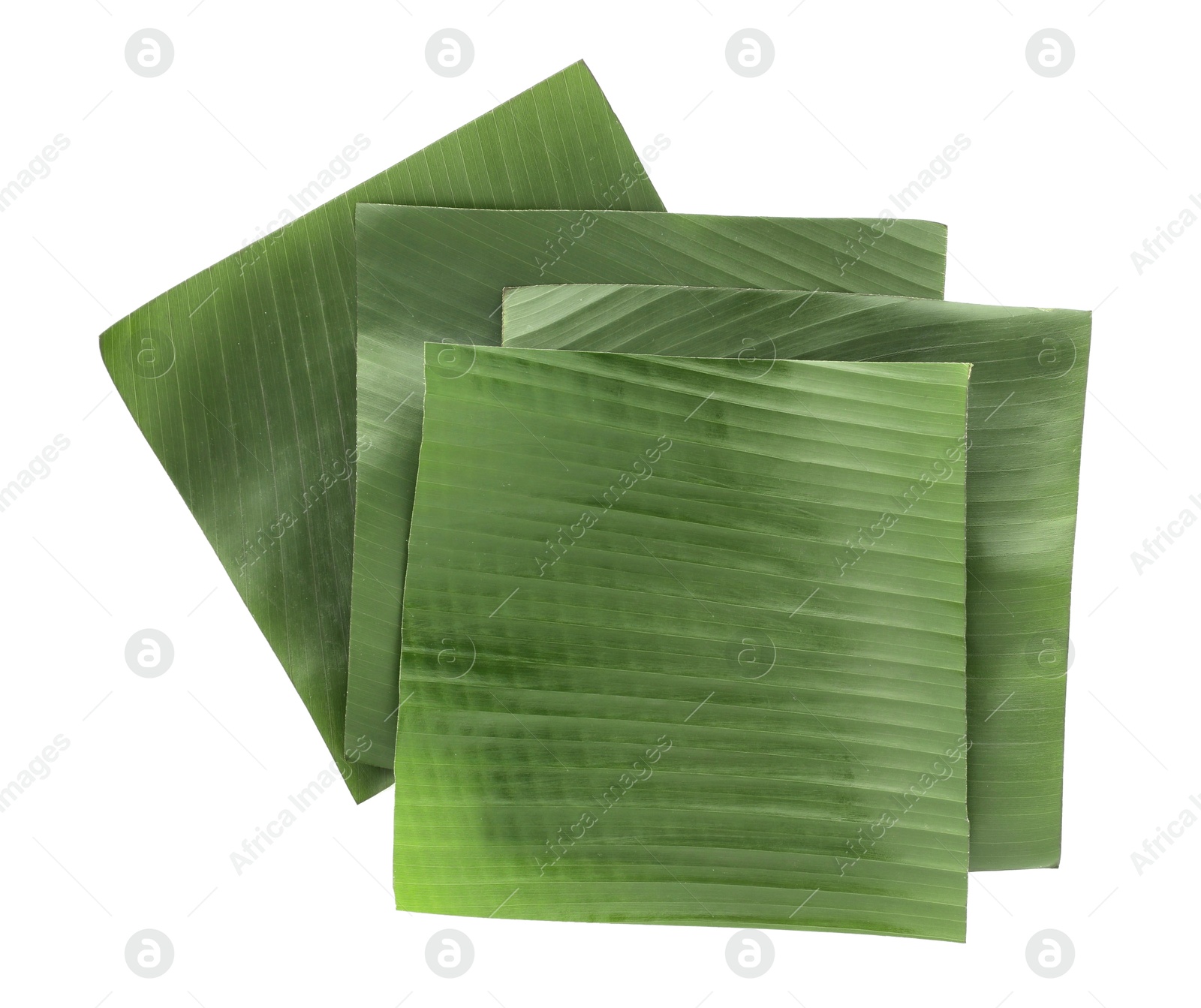 Photo of Pieces of banana leaves isolated on white, top view. Traditional meal serving