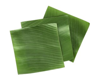 Photo of Pieces of banana leaves isolated on white, top view. Traditional meal serving