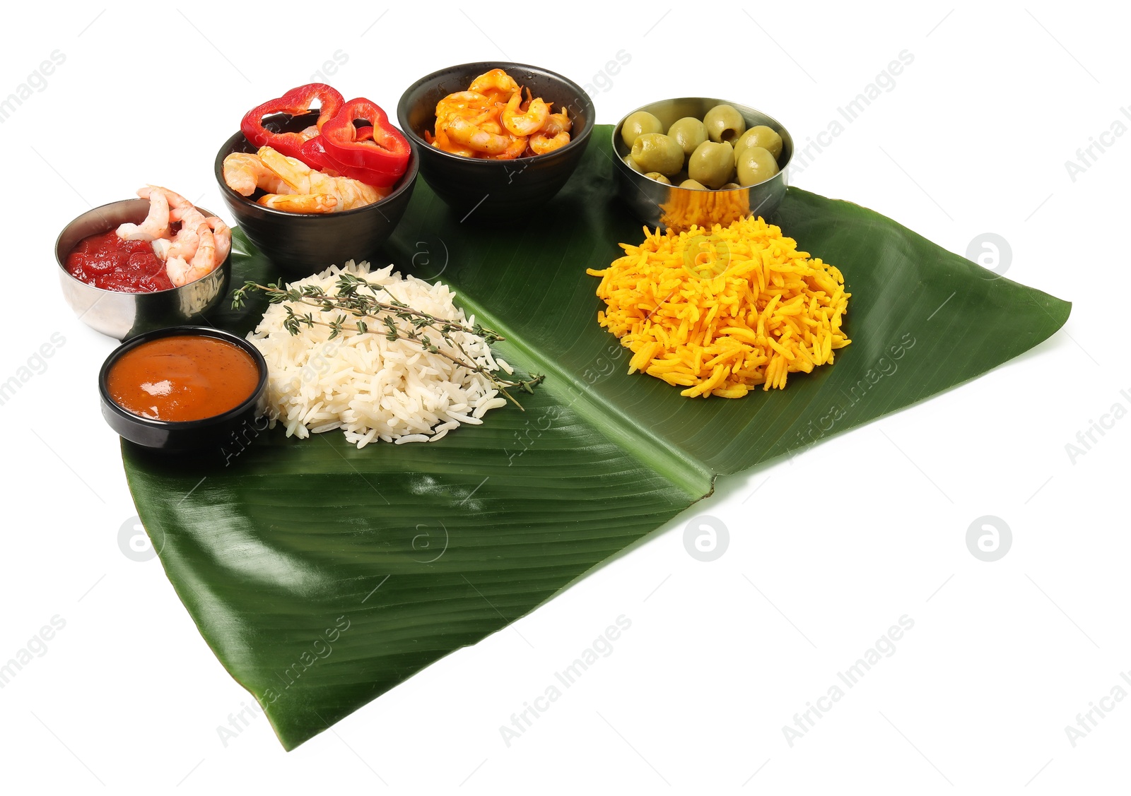 Photo of Cut banana leaf with different food and sauces isolated on white. Healthy eco serving