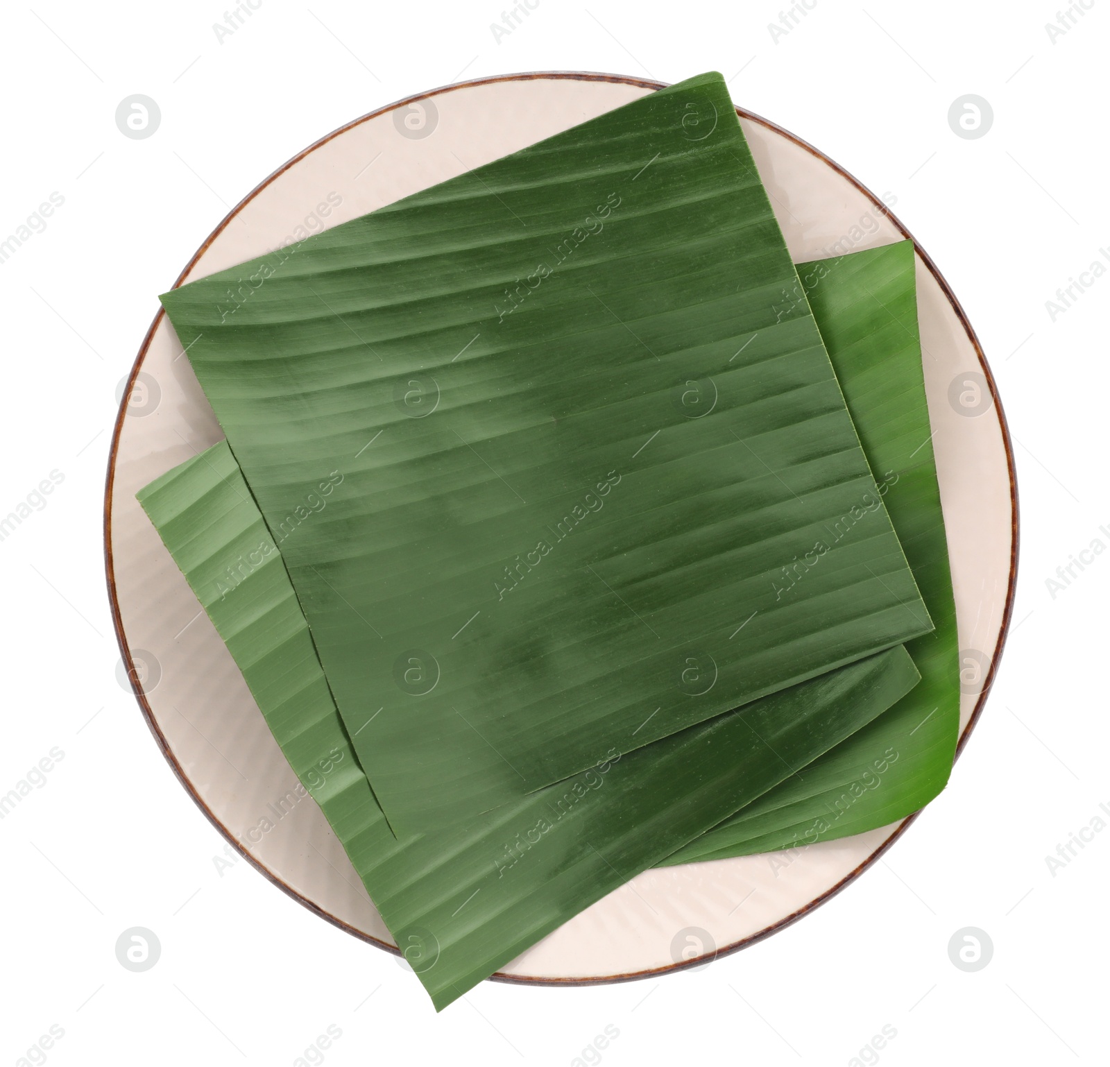 Photo of Pieces of banana leaves isolated on white, top view. Traditional meal serving