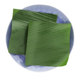 Photo of Pieces of banana leaves isolated on white, top view. Traditional meal serving