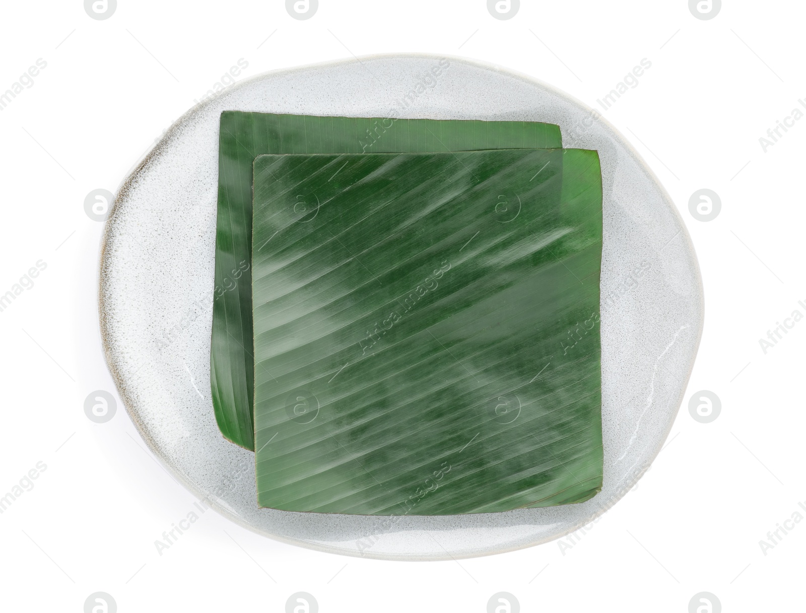 Photo of Pieces of banana leaves isolated on white, top view. Traditional meal serving