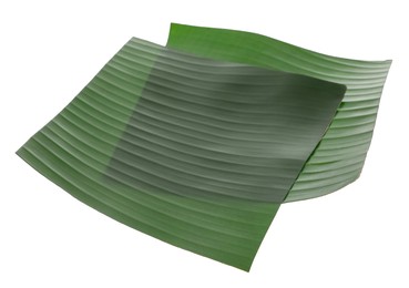 Photo of Pieces of banana leaves isolated on white. Traditional meal serving