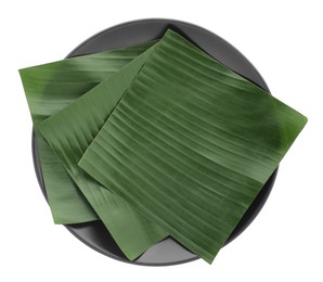 Photo of Pieces of banana leaves isolated on white, top view. Traditional meal serving