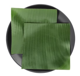 Photo of Pieces of banana leaves isolated on white, top view. Traditional meal serving