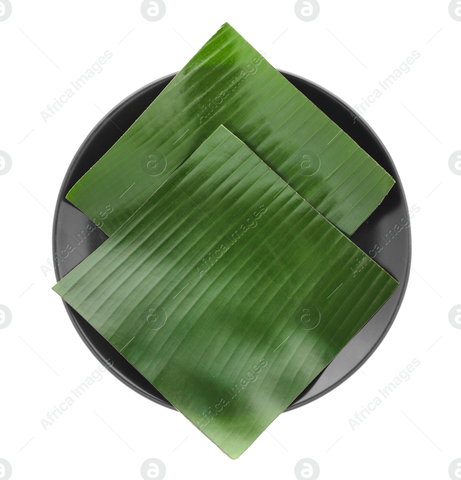 Photo of Pieces of banana leaves isolated on white, top view. Traditional meal serving