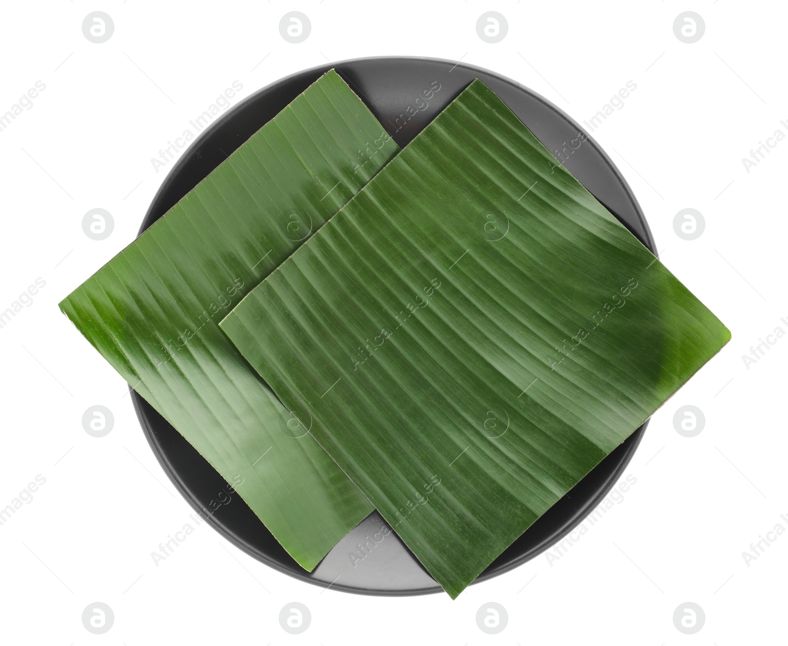 Photo of Pieces of banana leaves isolated on white, top view. Traditional meal serving