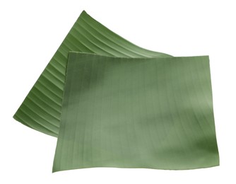 Photo of Pieces of banana leaves isolated on white. Traditional meal serving