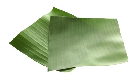 Photo of Pieces of banana leaves isolated on white. Traditional meal serving