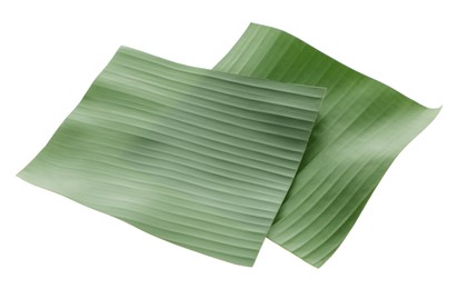 Photo of Pieces of banana leaves isolated on white. Traditional meal serving