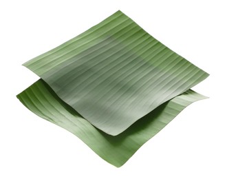 Photo of Pieces of banana leaves isolated on white. Traditional meal serving