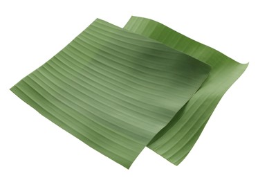 Photo of Pieces of banana leaves isolated on white. Traditional meal serving