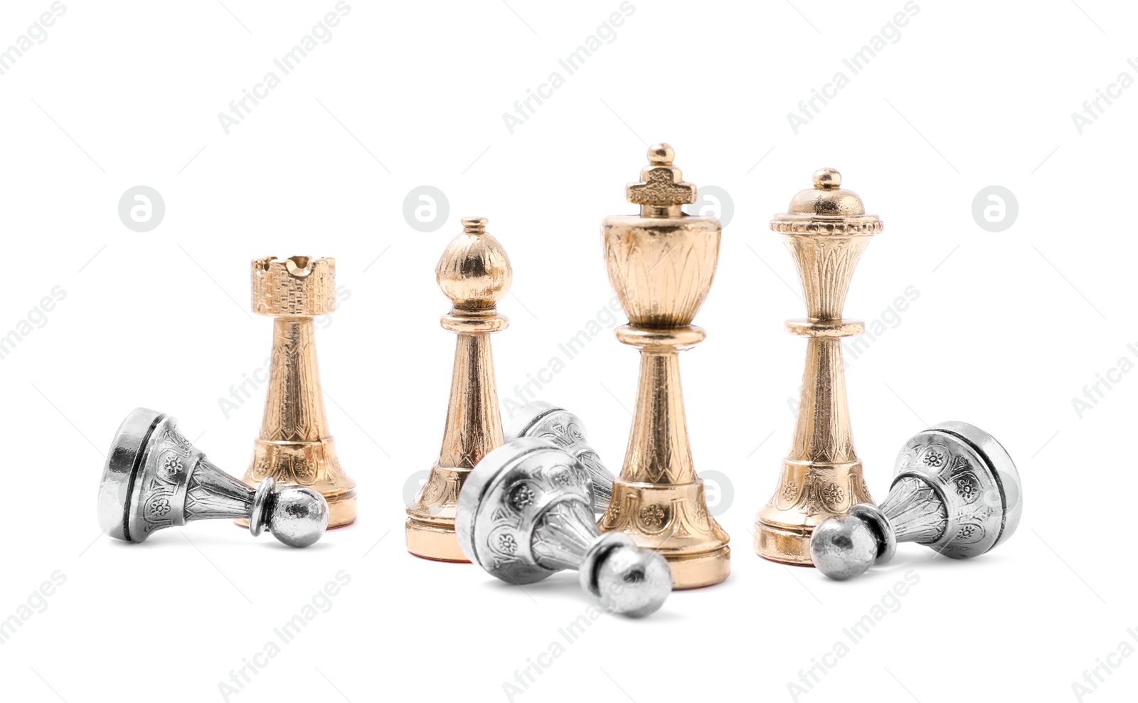 Photo of Golden chess pieces among fallen silver pawns on white background. Competition concept