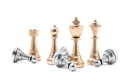 Photo of Golden chess pieces among fallen silver pawns on white background. Competition concept