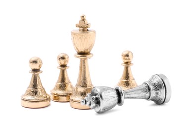 Photo of Golden chess pieces among fallen silver one on white background. Competition concept