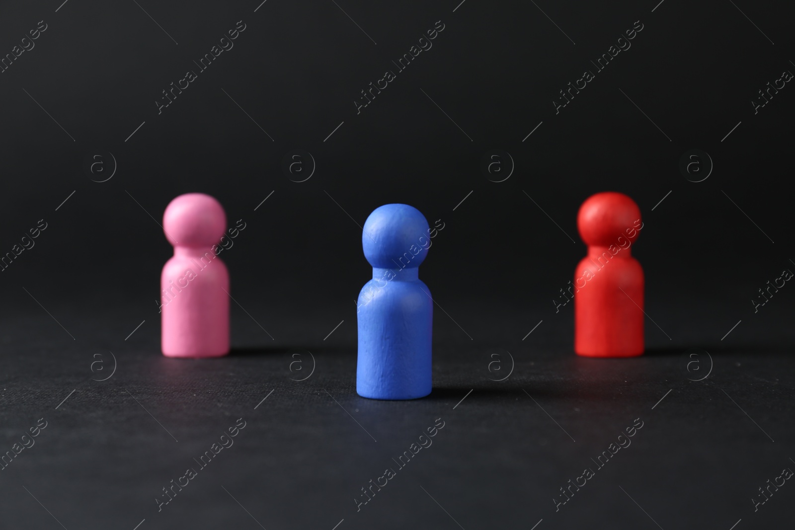 Photo of Competition concept. Different human figures on black background