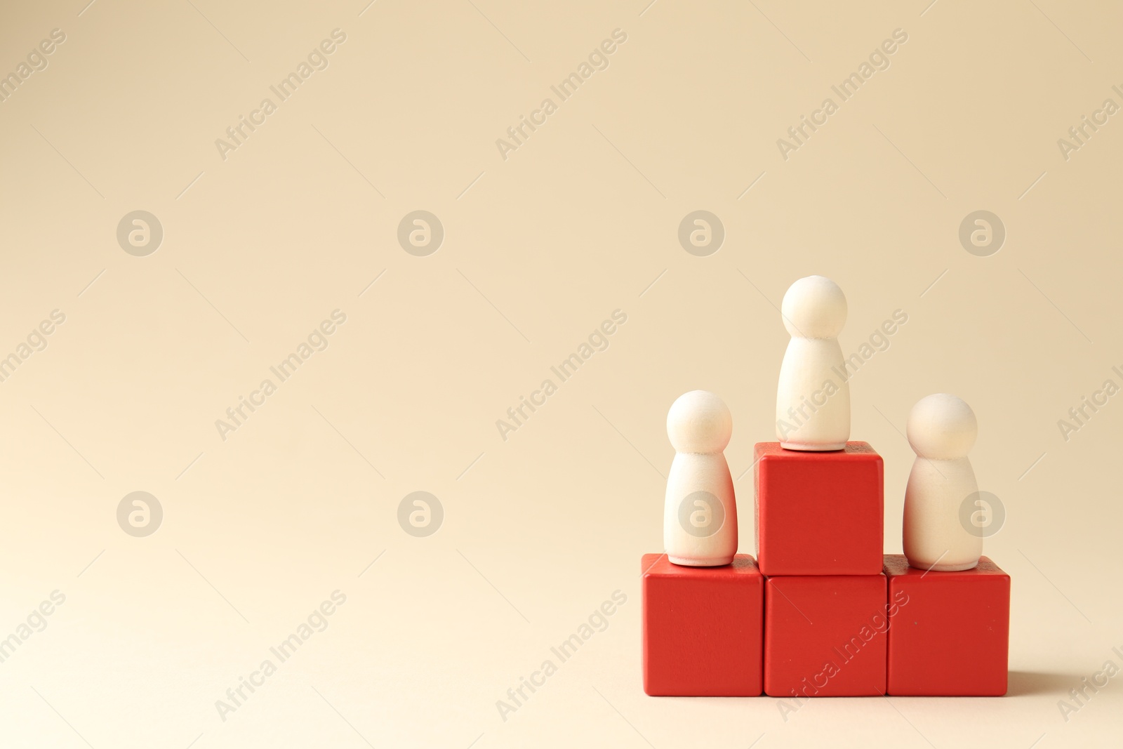 Photo of Competition concept. Human figures on wooden cubes against beige background, space for text