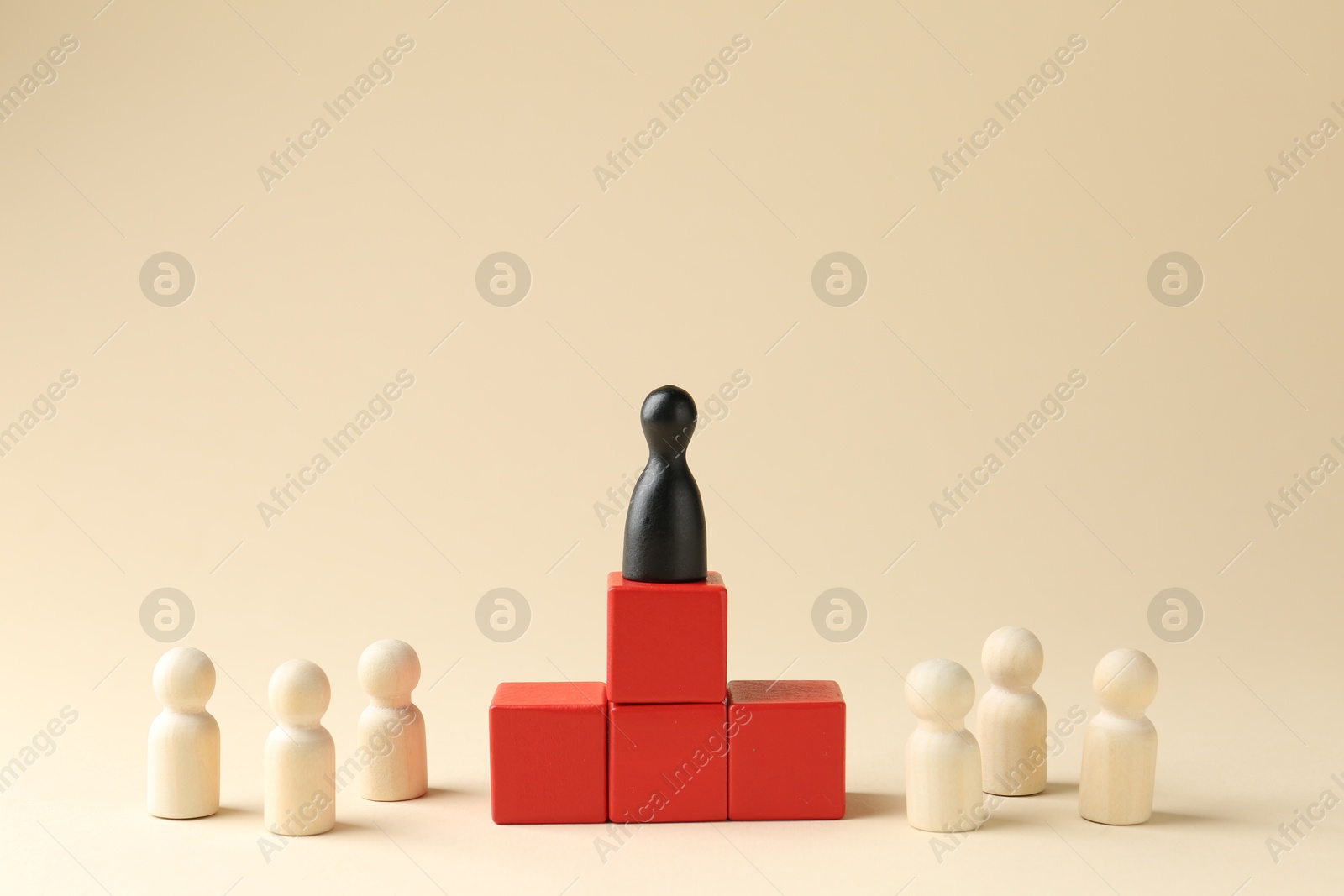 Photo of Competition concept. Human figures on wooden cubes and other ones behind against beige background, space for text