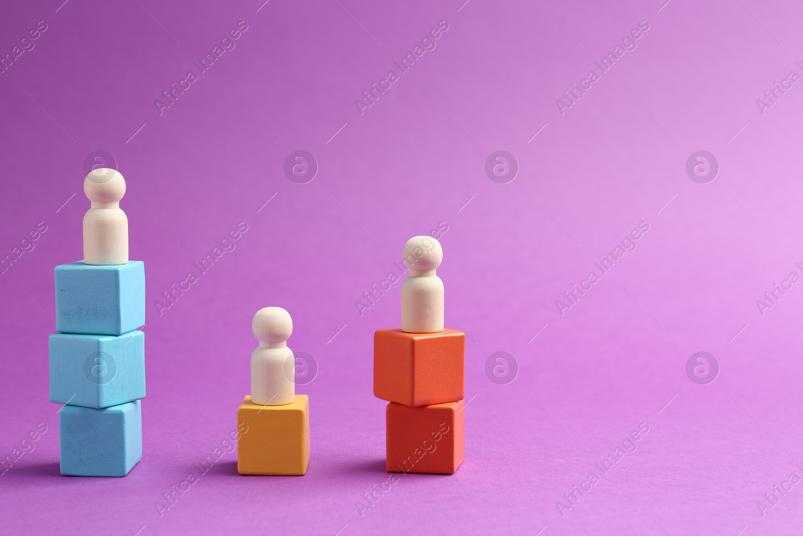 Photo of Human figures on stacked wooden cubes against violet background, space for text. Competition concept