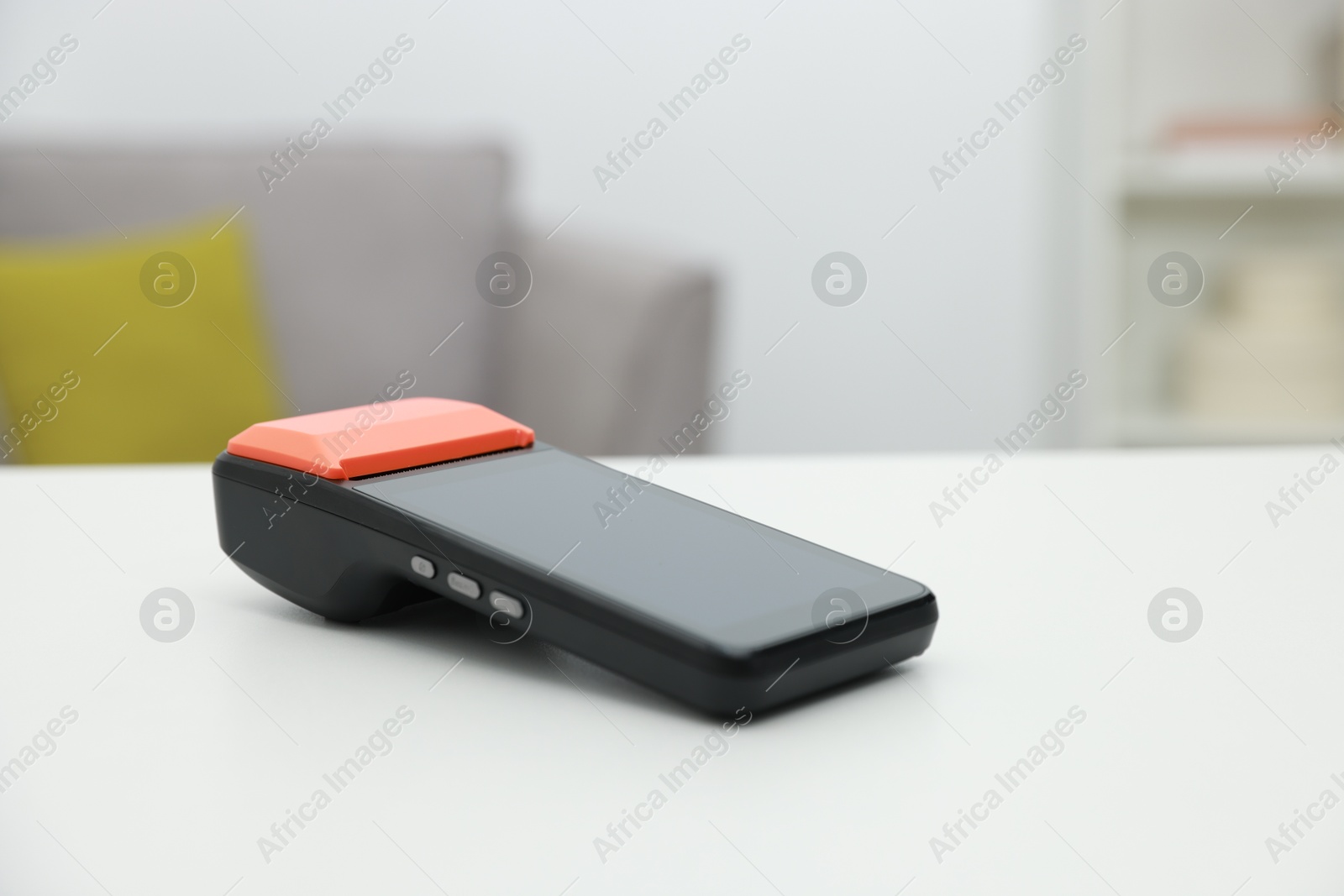 Photo of Payment terminal on white table indoors, closeup. Space for text