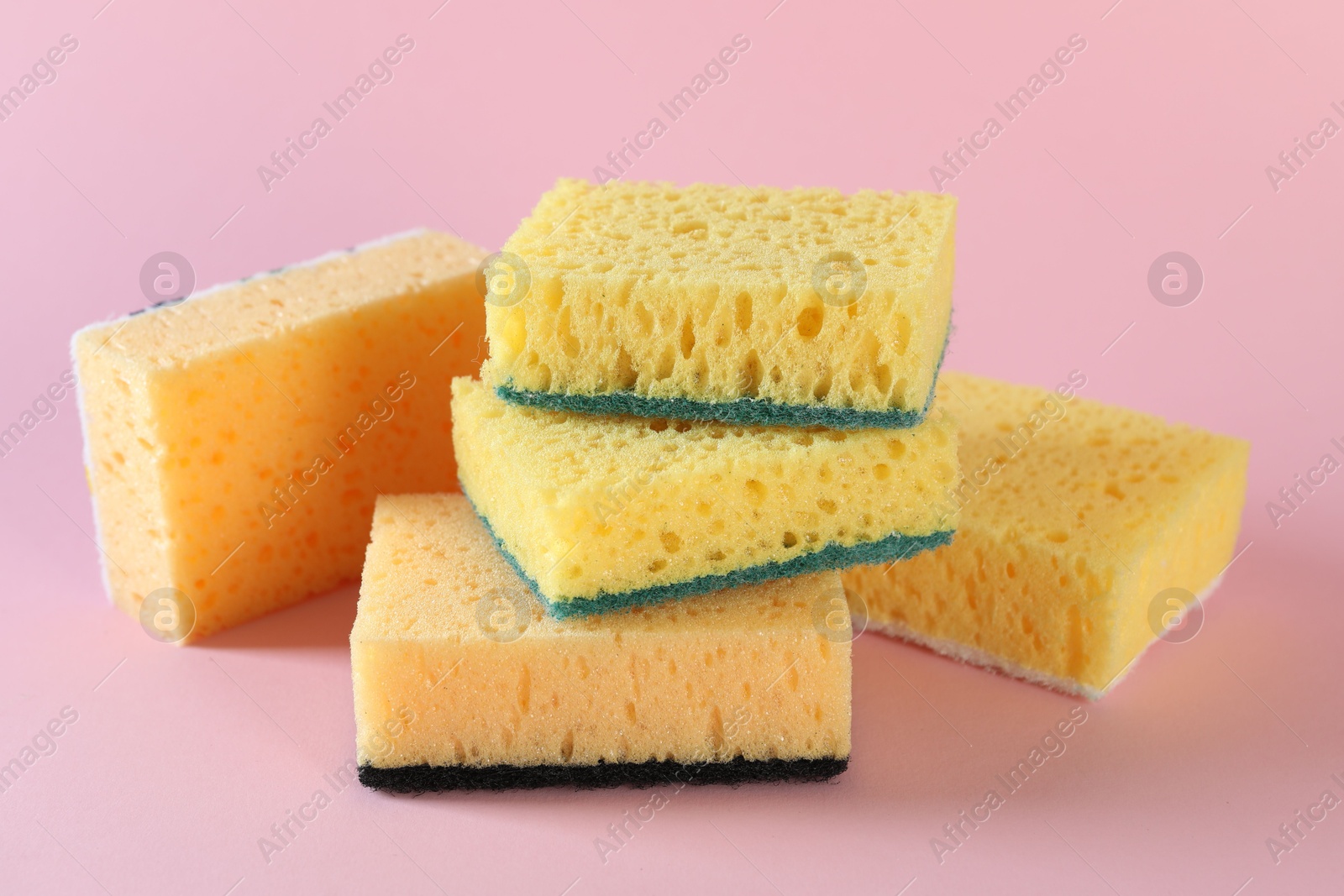 Photo of Different clean sponges on pink background, closeup